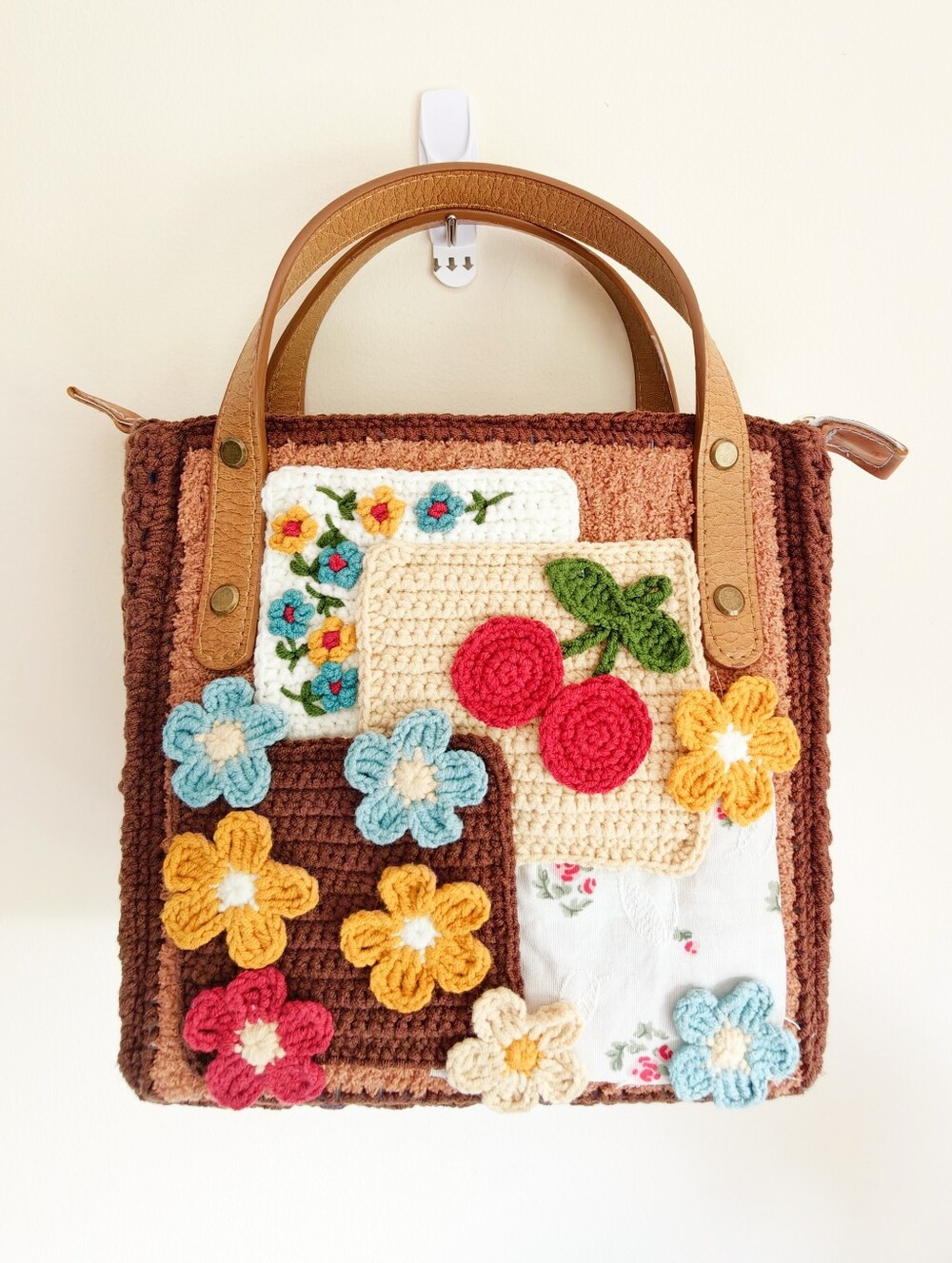 Handmade Crochet Mini Bag with Brown Base and Multicolor Floral Appliqués